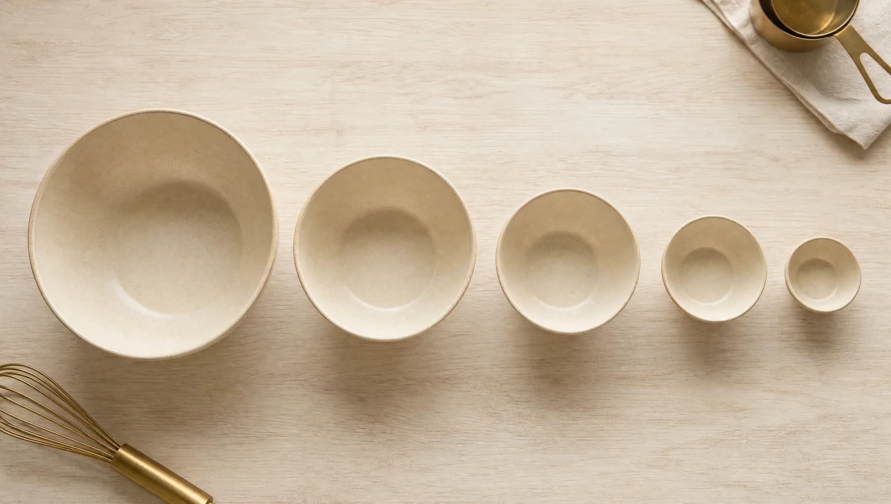 Five nested mixing bowls pulled apart in a descending line